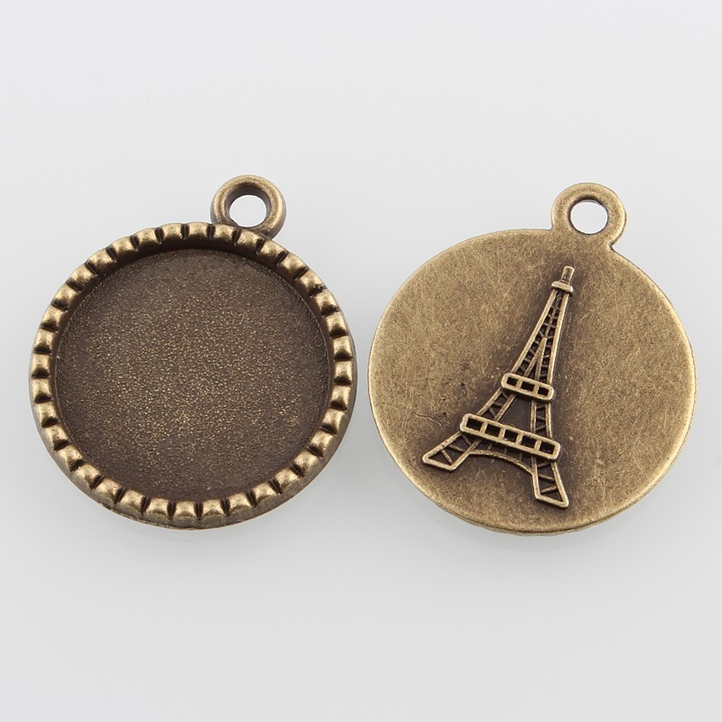 Support de cabochon rond et plat avec tour Eiffel à l'arrière en décor. Couleur bronze antique